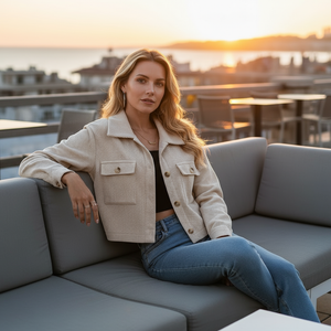 Woman sitting on a rooftop with a cityscape in the background