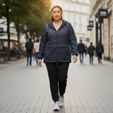 Woman in a blue raincoat walking on a city street