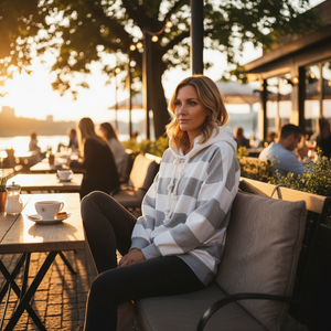 Woman sitting outdoors at a cafe with sunset in the background