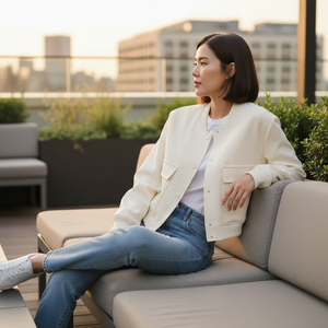 Woman sitting on a rooftop with a cityscape in the background