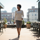 Woman walking on a rooftop patio with cityscape in the background