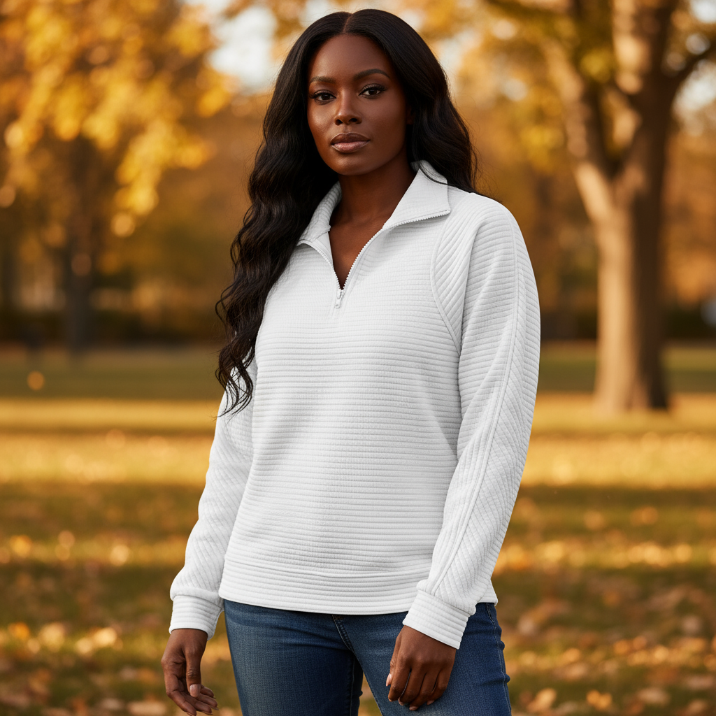 Woman wearing a white long-sleeve shirt in an outdoor setting with trees and grass.