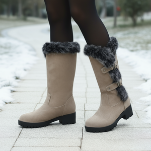 Beige winter boots with fur trim on a snowy ground