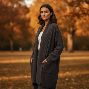 Woman wearing a long dark gray cardigan in an autumn setting