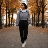 Woman walking on a sidewalk with autumn trees in the background